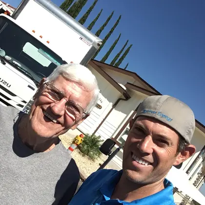 Ben from Burmax Energy with a customer beside the install truck outside his home