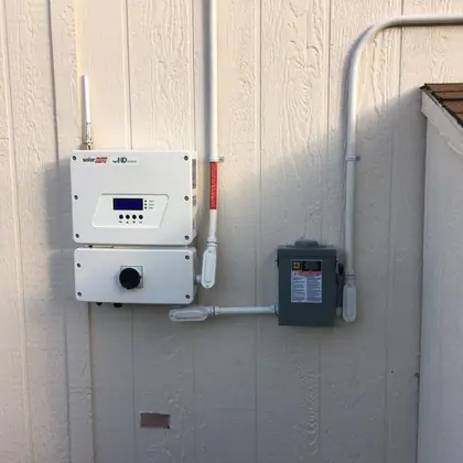 Neatly installed SolarEdge inverter and disconnect with clean conduit runs