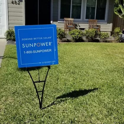 SunPower yard sign on the front lawn of a completed solar installation