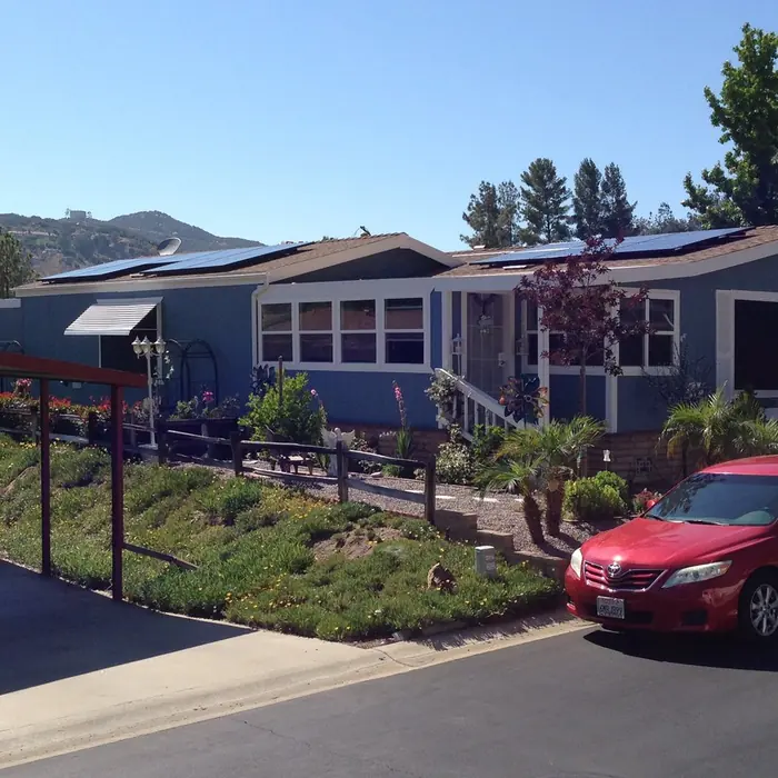 Solar panels installed across the roof of a manufactured home in a San Diego community